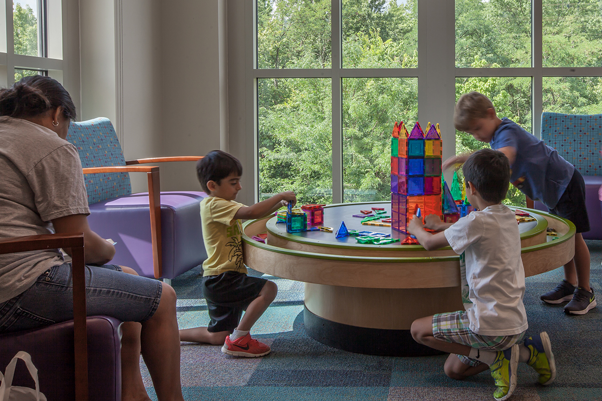 children playing with a multi-activity table